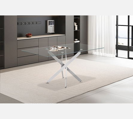 Table de salle à manger Lasi dessus verre et pieds croisées chromés.