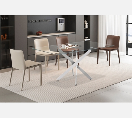 Table de salle à manger Lasi dessus verre pieds croisées chromés.